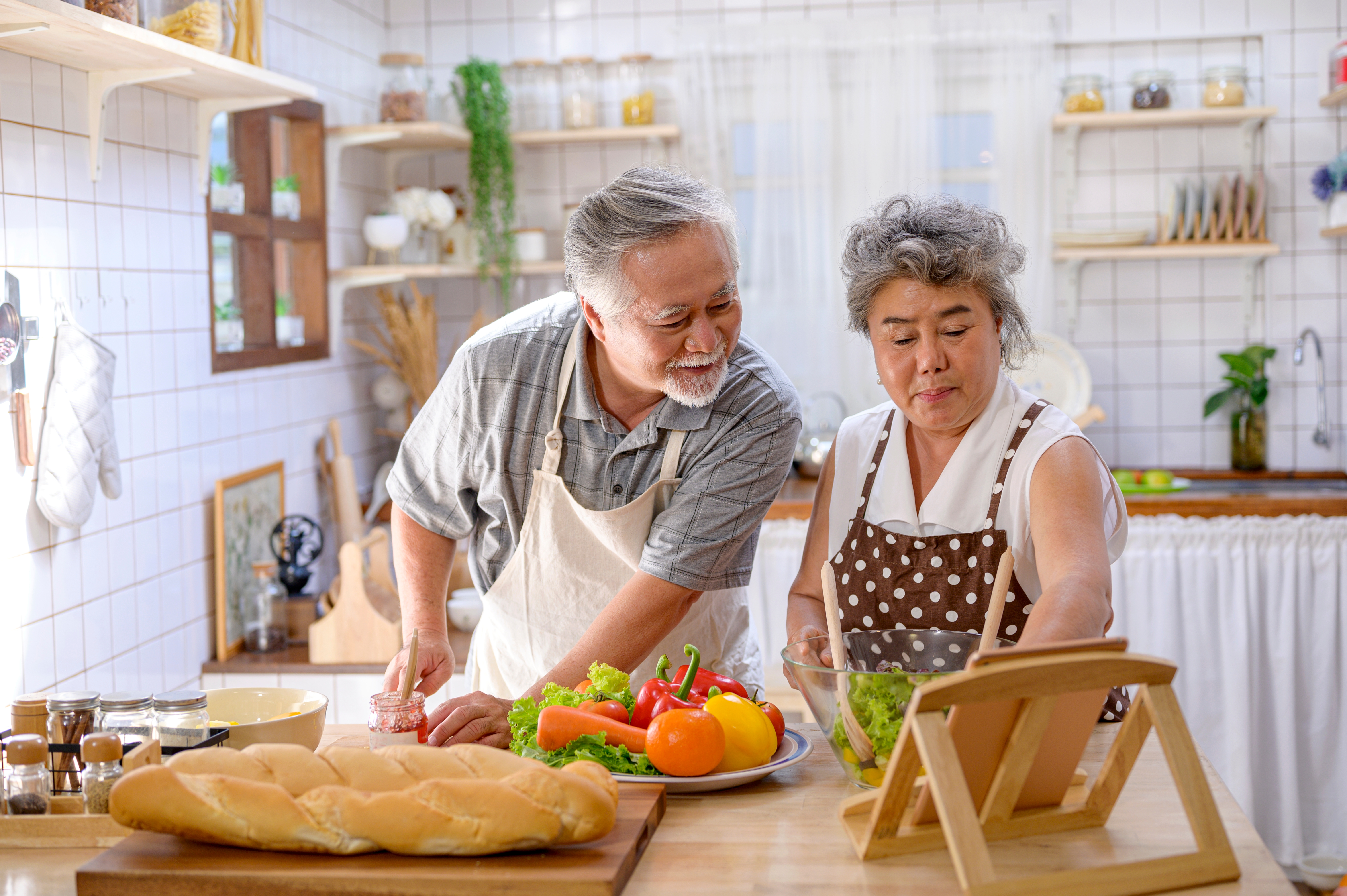 Older couple cooking happily together.