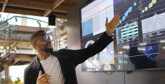 young sales enablement professional using AI technology to improve outcomes