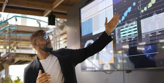 young sales enablement professional using AI technology to improve outcomes