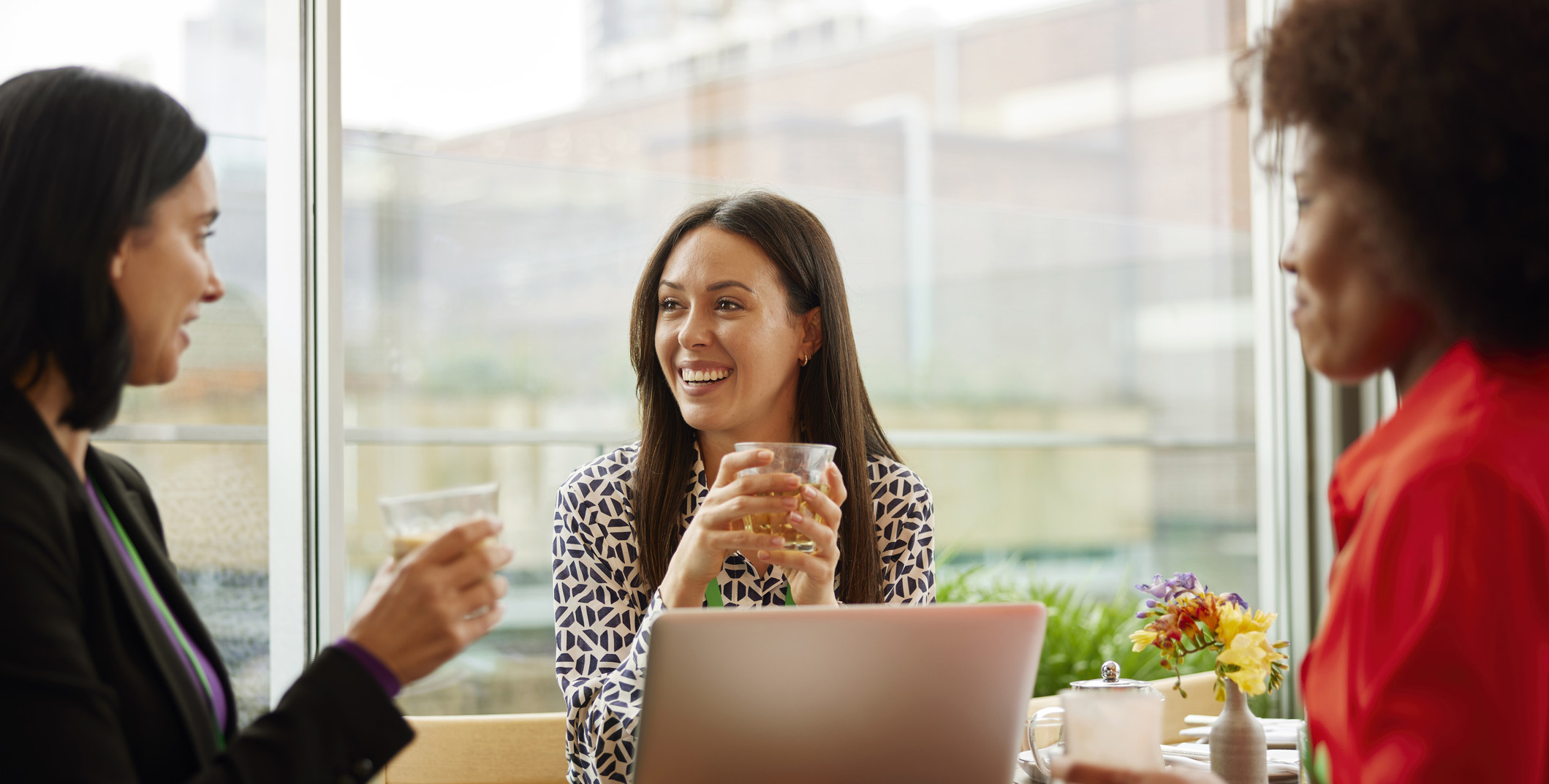 sales enablement leaders at a conference table celebrating their crowdsourced sales enablement content