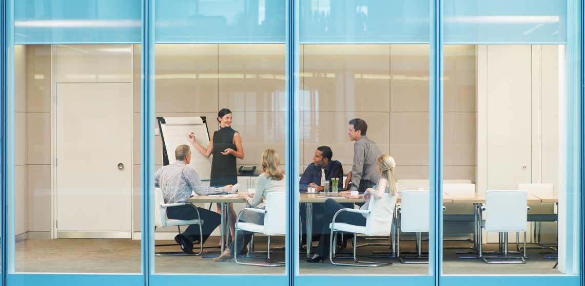 Businesspeople having meeting in conference room discussing sales methodology