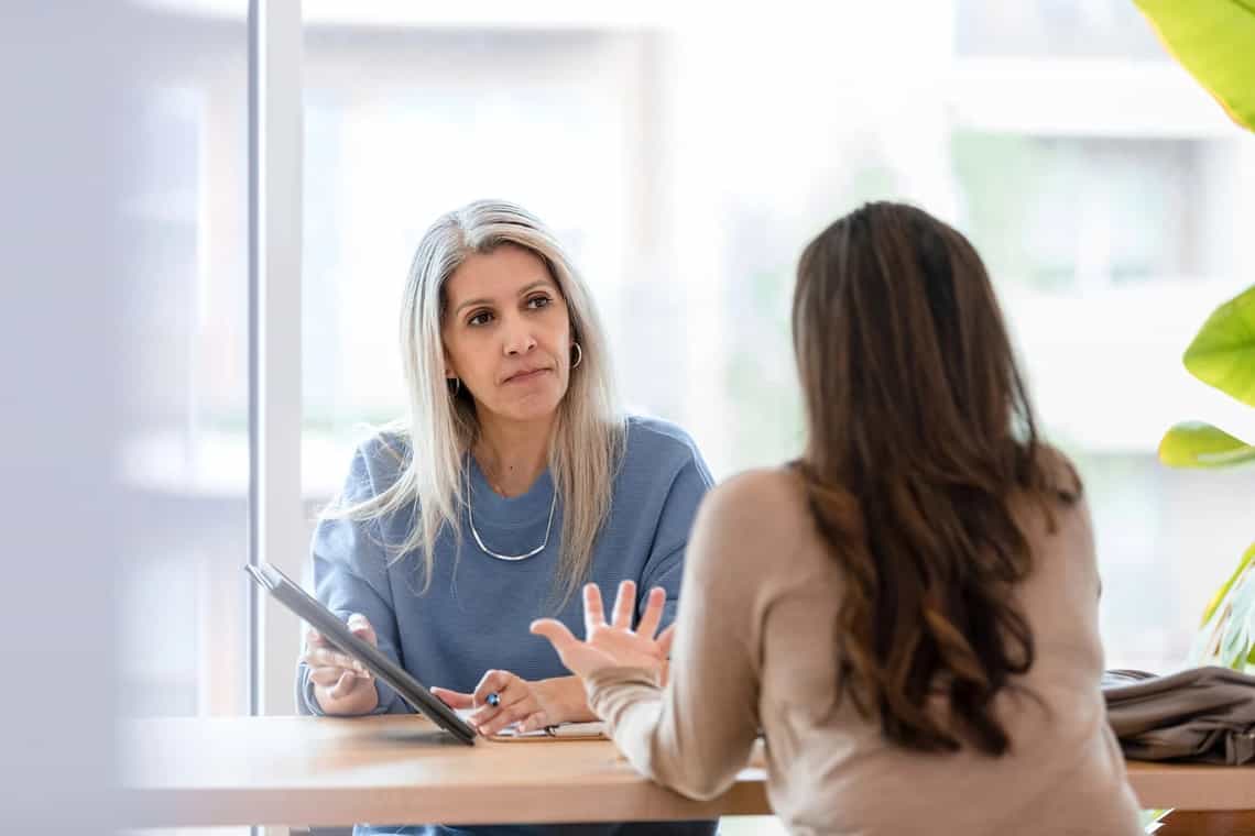 A sales manager acting as a coach in conversation with a seller
