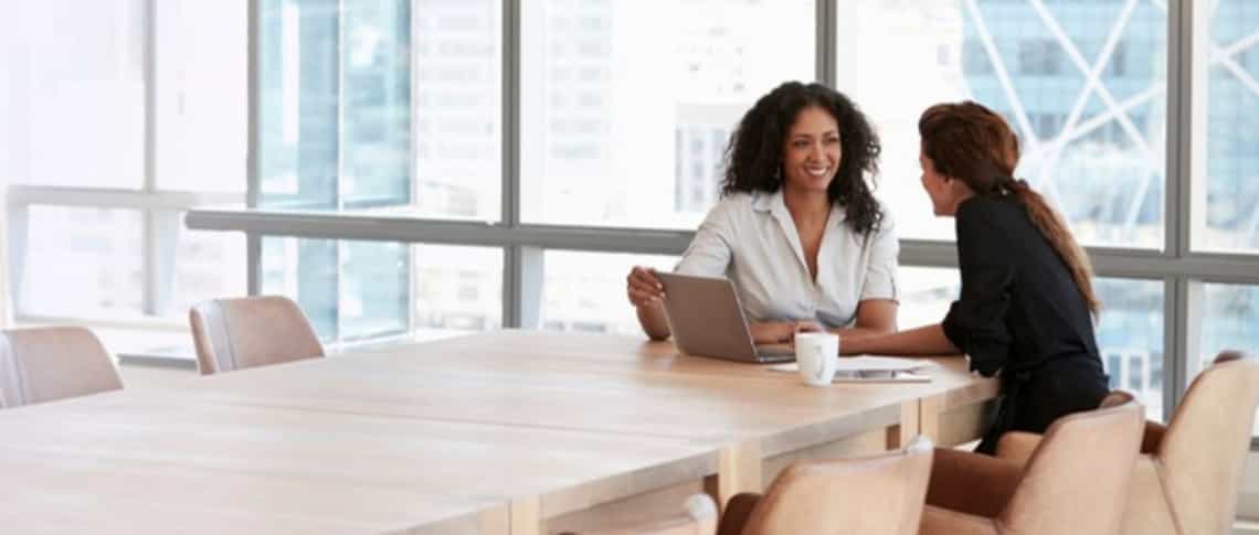 A manager and seller in a coaching conversation, reflecting a culture where coaching is routine.