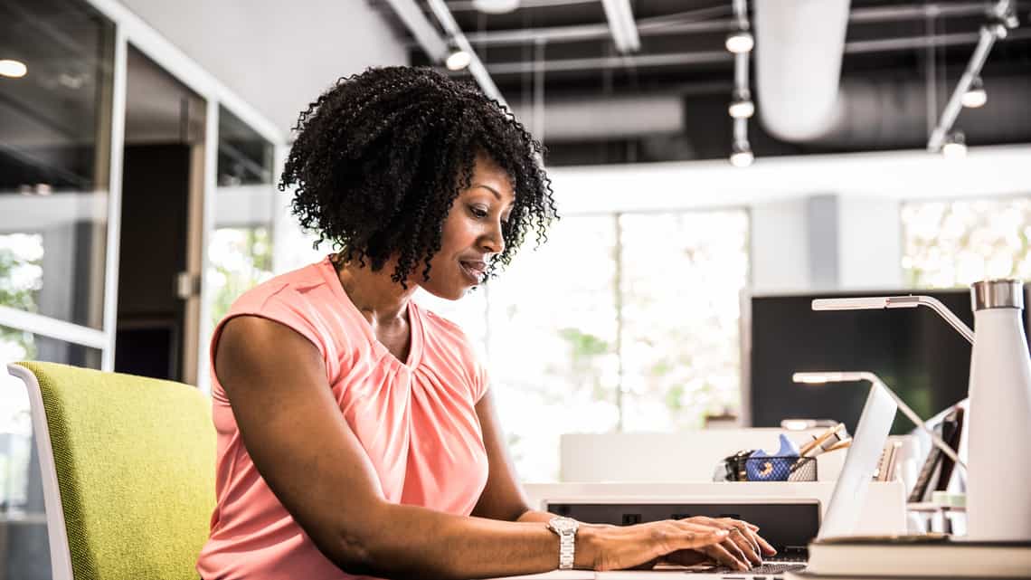 sales enablement manager sitting at her computer organizing content to empower her sales team to more effectively engage customers