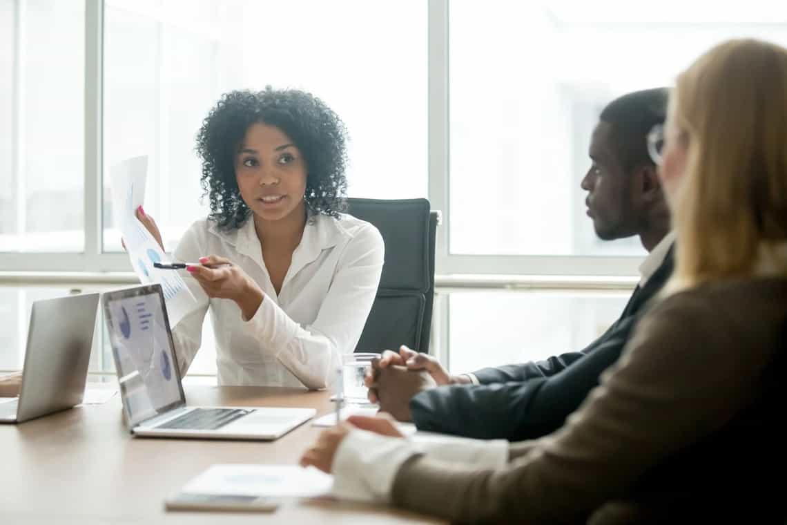 A sales leader and team member reviewing performance data together.