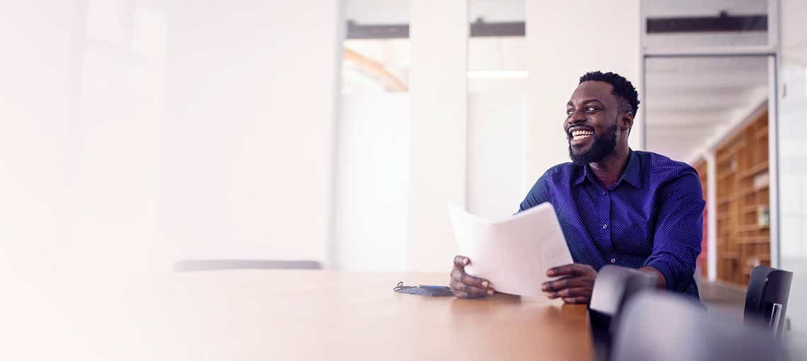 stylish african american salesman engaging a buyer off camera using solution messaging skills