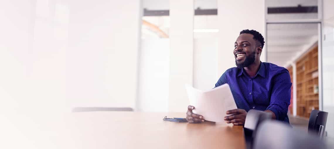 stylish african american salesman engaging a buyer off camera using solution messaging skills
