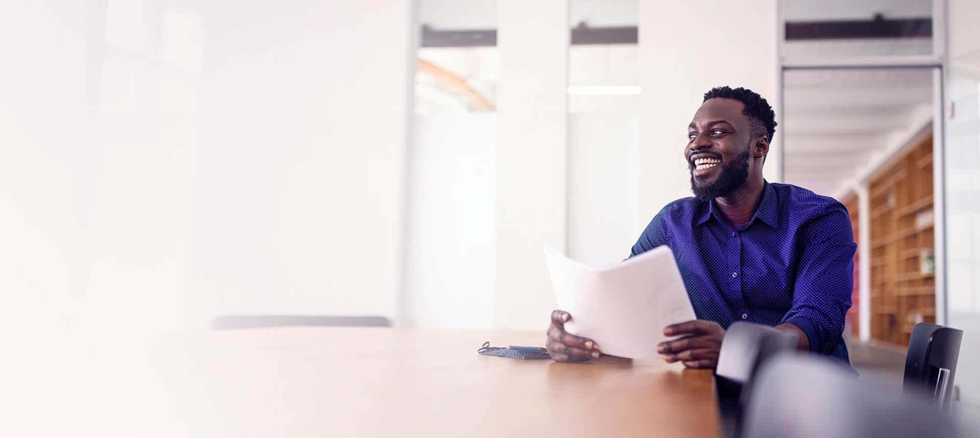 stylish african american salesman engaging a buyer off camera using solution messaging skills