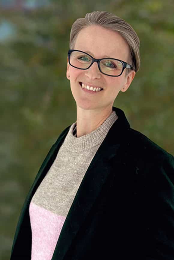 large image of richardson's chief product officer kate lewis against a forested background