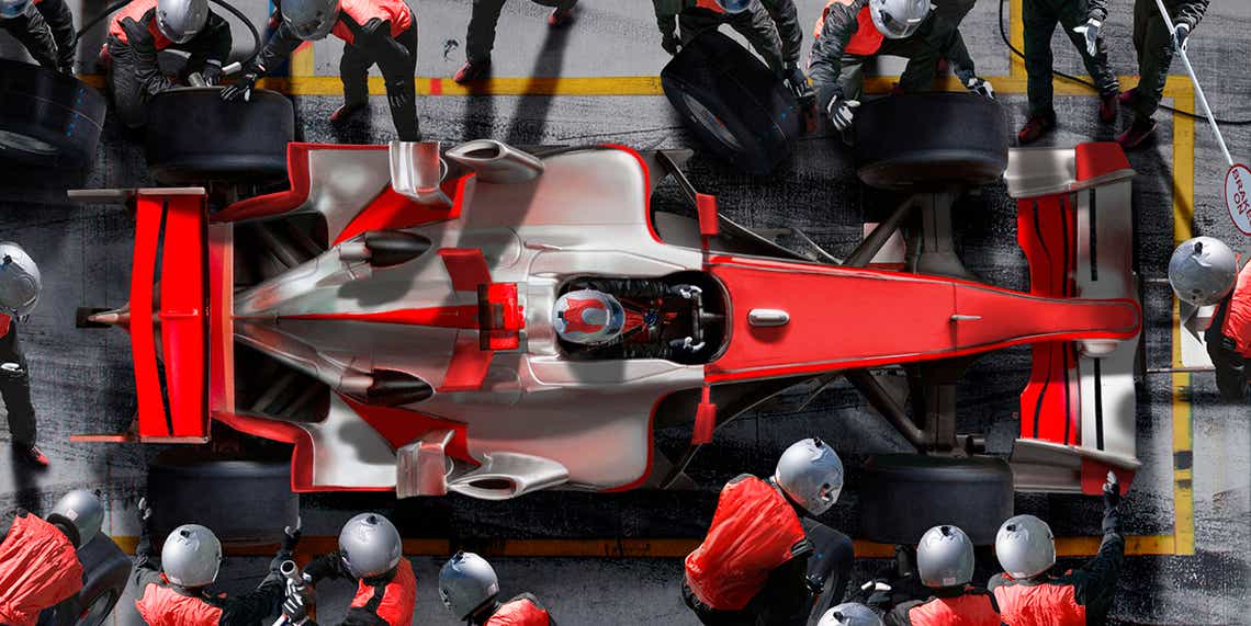 a formula one race car team working in the pit as a metaphor for a sales team delivering high performance outcomes