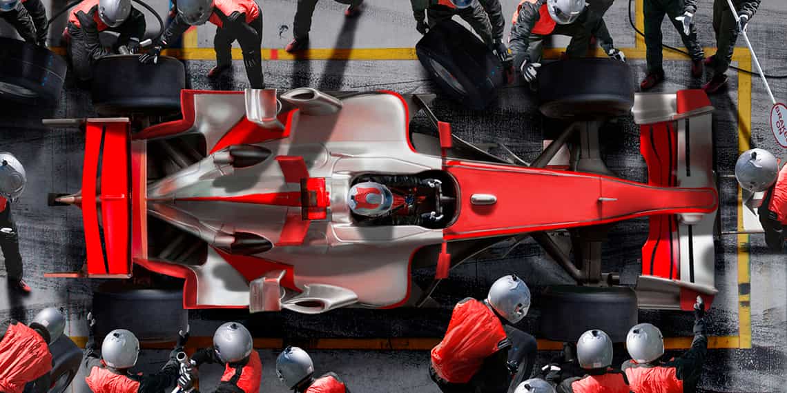 a formula one race car team working in the pit as a metaphor for a sales team delivering high performance outcomes