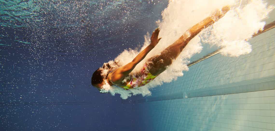 Woman diving into pool as metaphor for sales agility
