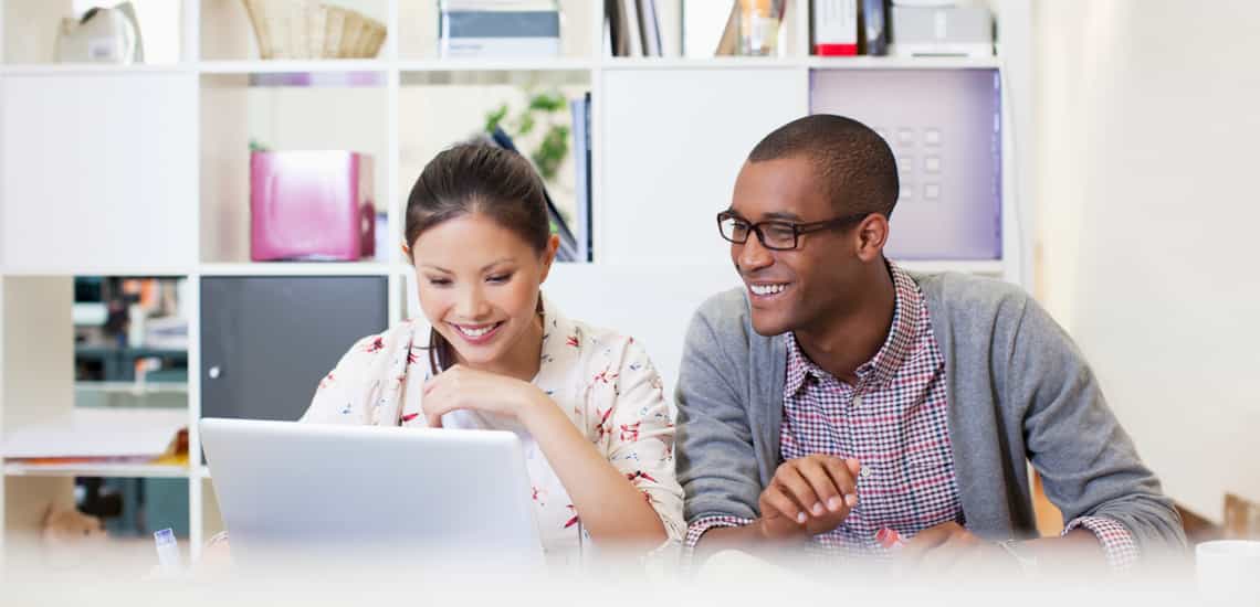 young revenue operations and sales operations professionals sitting together at a modern desk working together to optimize their organization's sales efforts