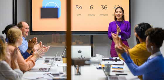 a chief revenue officer leading a team meeting - discussing how to achieve revenue goals