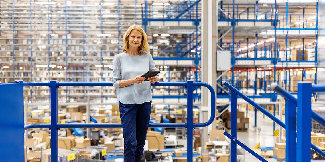 a female sales person in a warehouse using creative strategies to continue selling in the face of supply chain issues