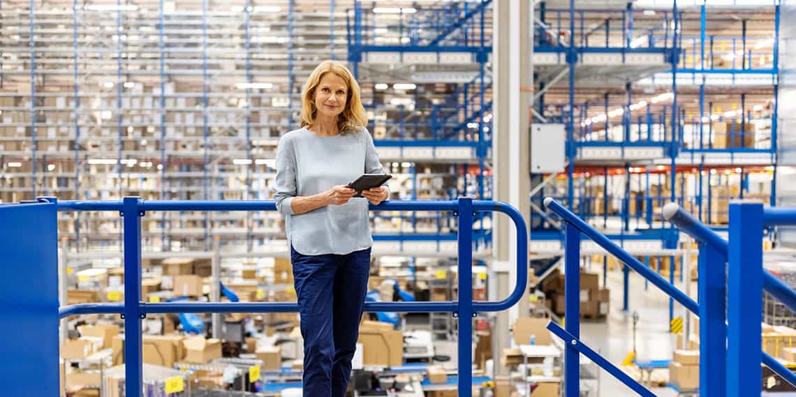a female sales person in a warehouse using creative strategies to continue selling in the face of supply chain issues