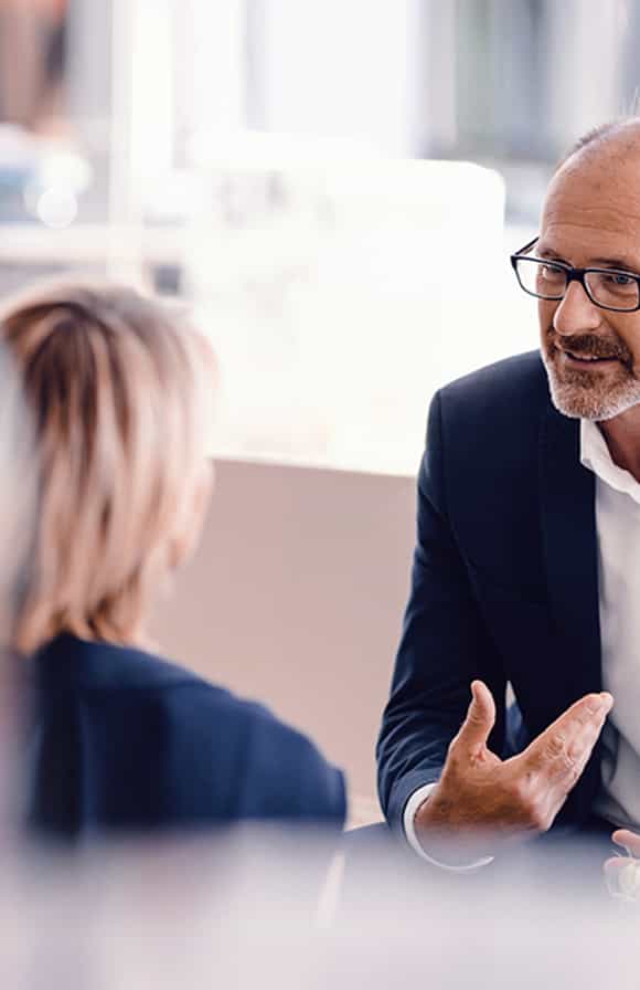 sales manager and sales rep engaged in a coaching session where the sales manager is using the skills they built in the driving salesperson accountability management training program from richardson.