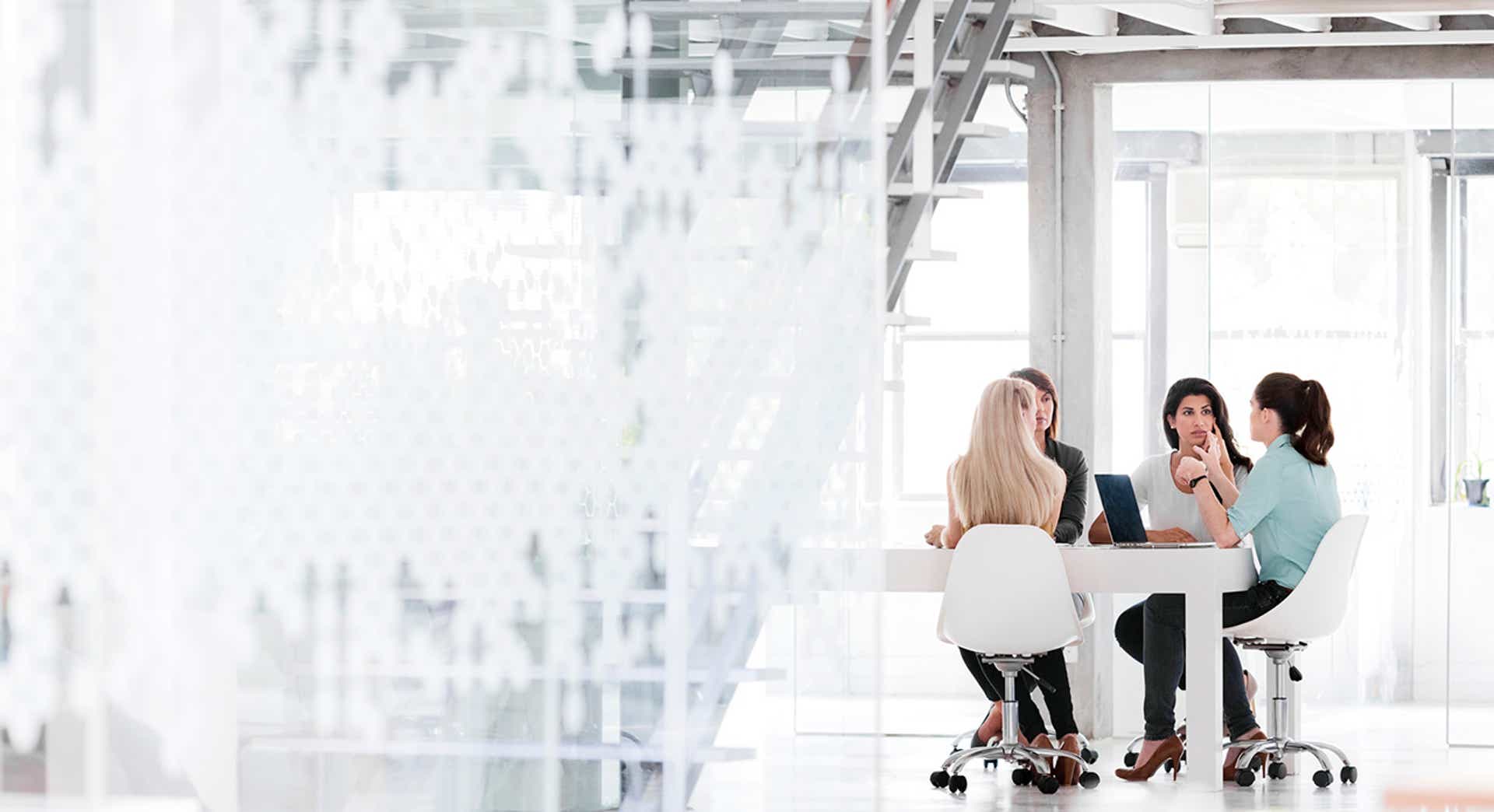 sales leader talking to her team in a conference room exercising agile sales management capabilities