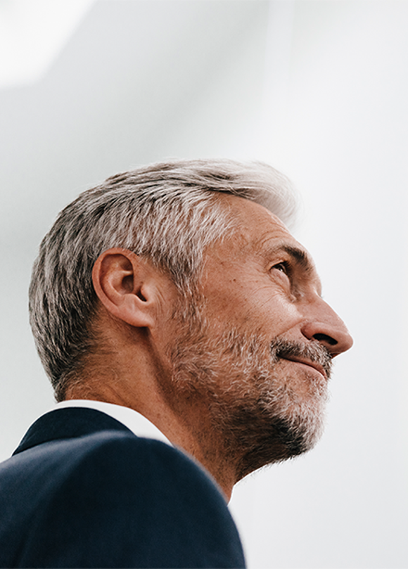 senior sales manager looking upwards as he effectively leads his sales reps to greater success because he has participated in training from Richardson