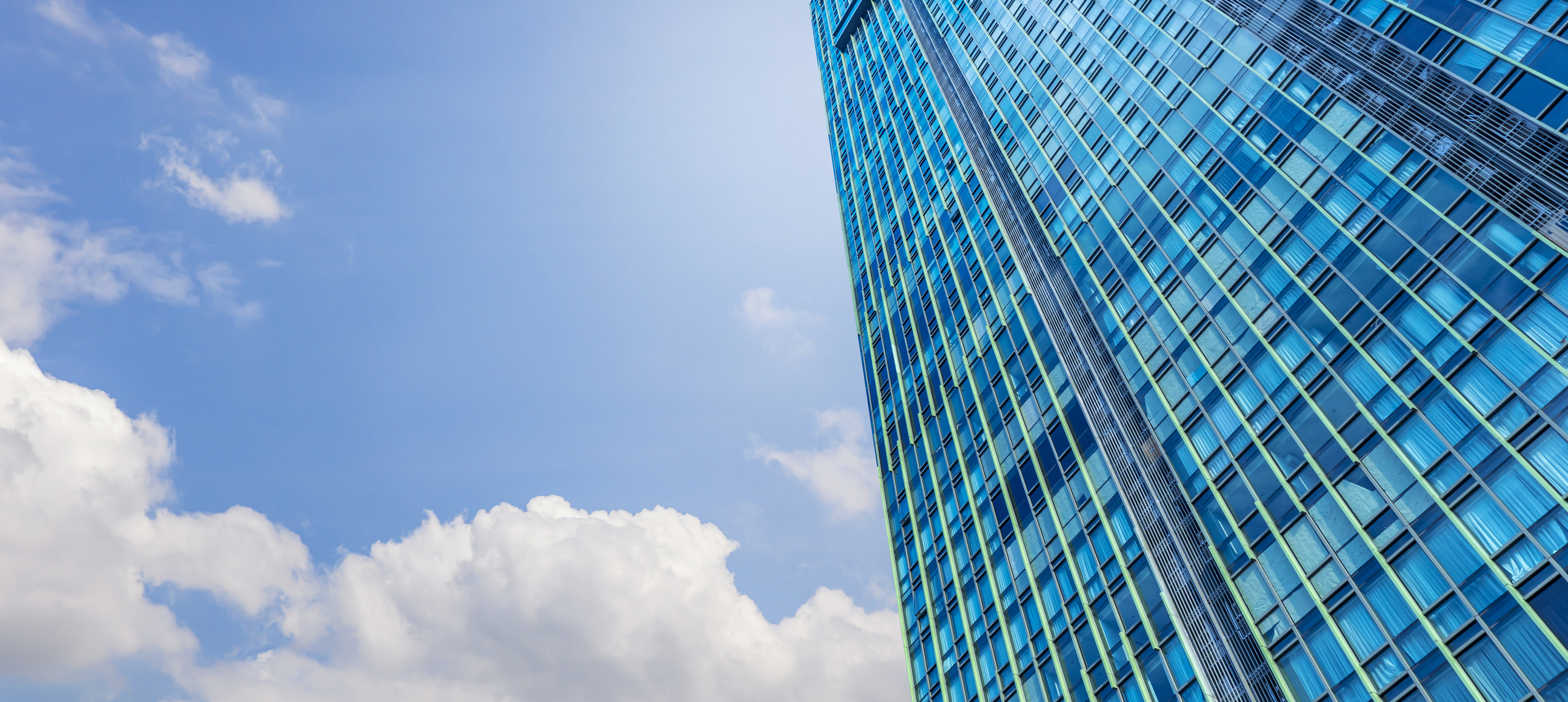 picture of a city skyline from the perspective of a person looking up from the street