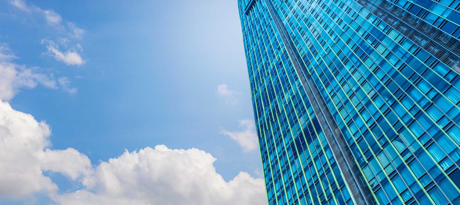 picture of a city skyline from the perspective of a person looking up from the street