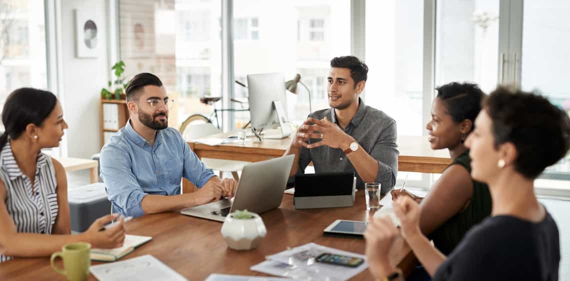 Sales leader listening to team members during an open discussion
