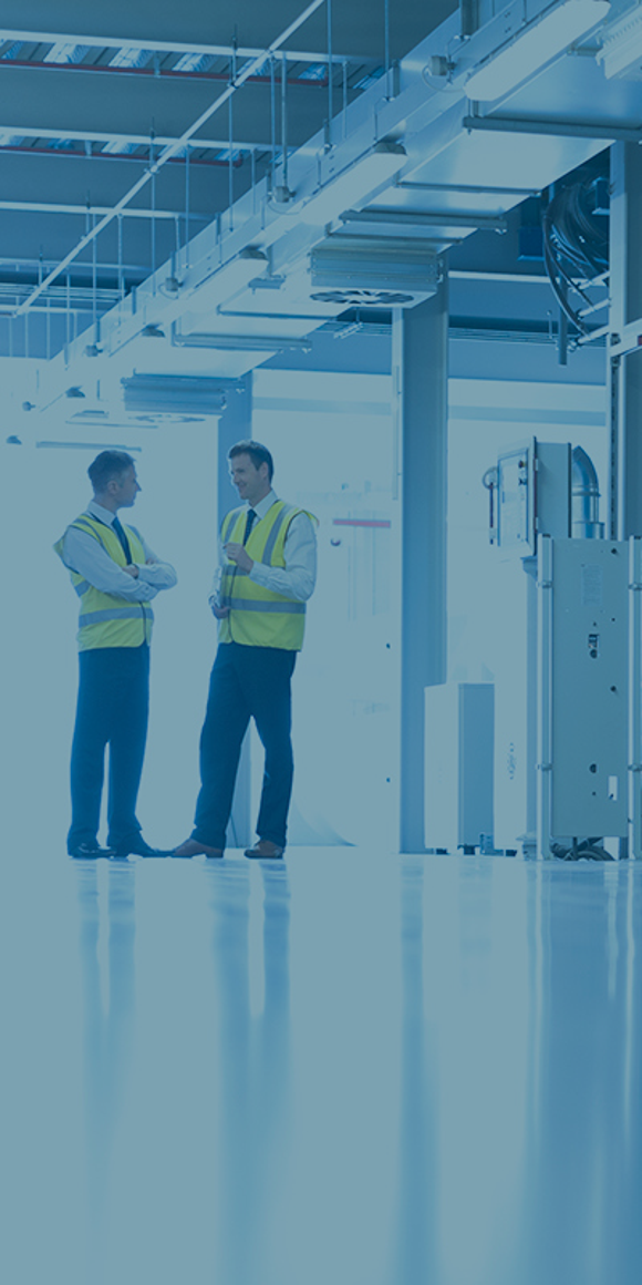 two men in the background in an industrial setting