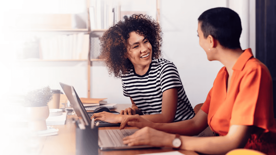 two channel partner managers smiling during a meeting because the channel partner management strategy that Richardson gave them is driving success