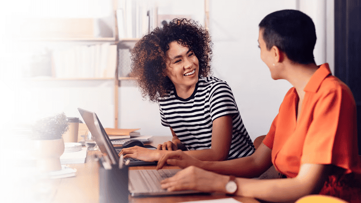 two channel partner managers smiling during a meeting because the channel partner management strategy that Richardson gave them is driving success