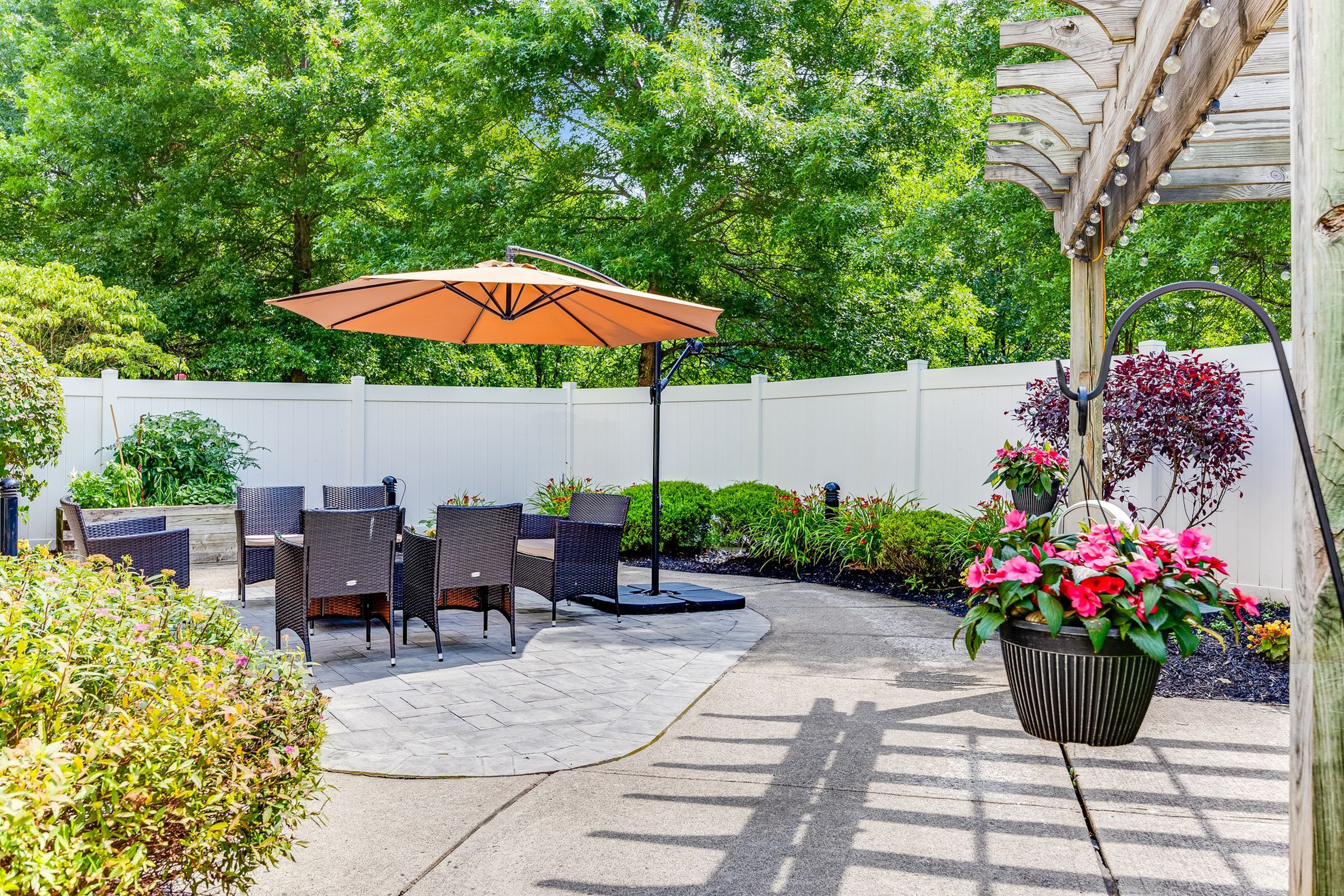 Backyard patio at Monarch Basking Ridge with chairs and umbrella