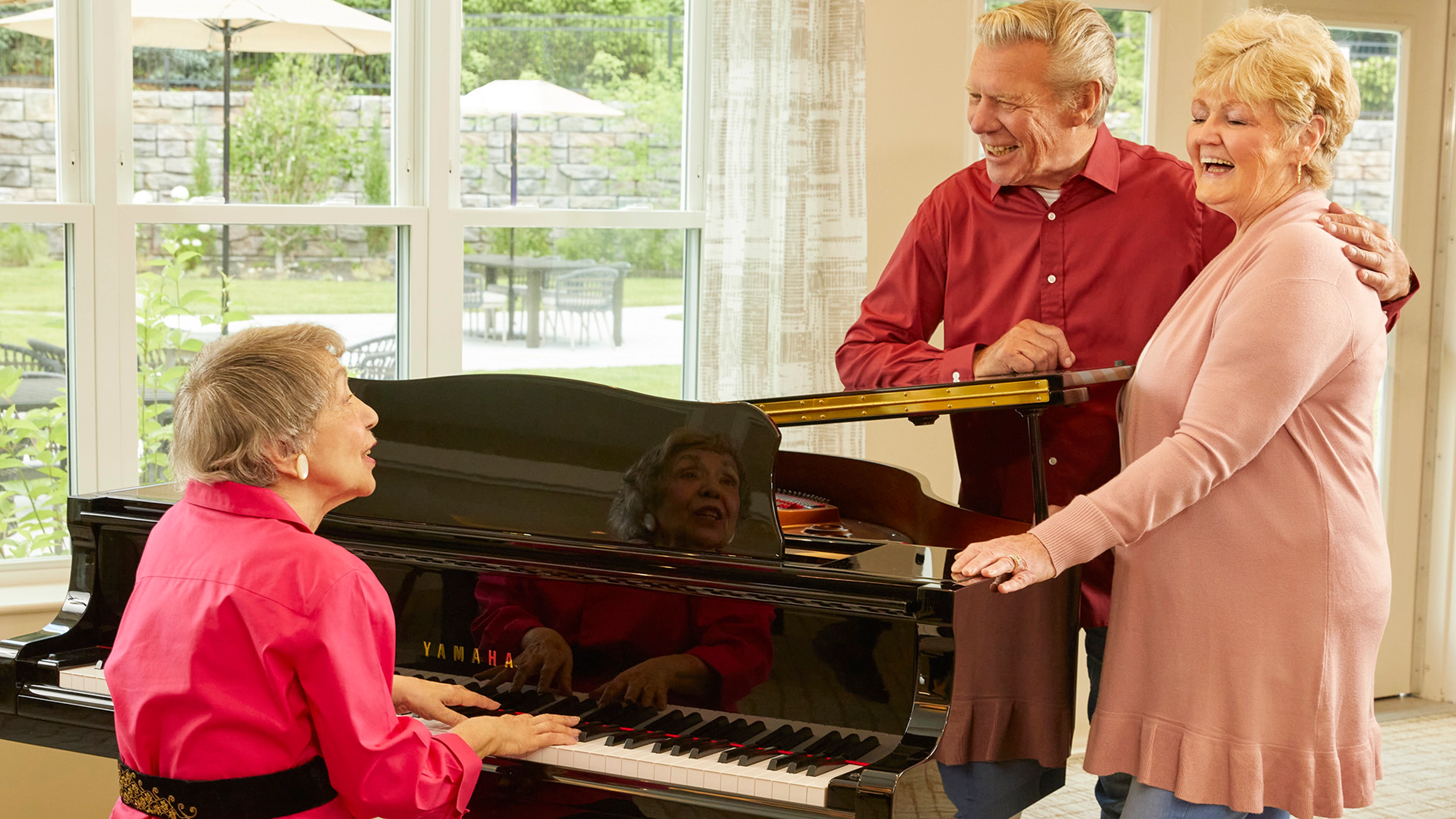 Woman and Couple singing at Piano