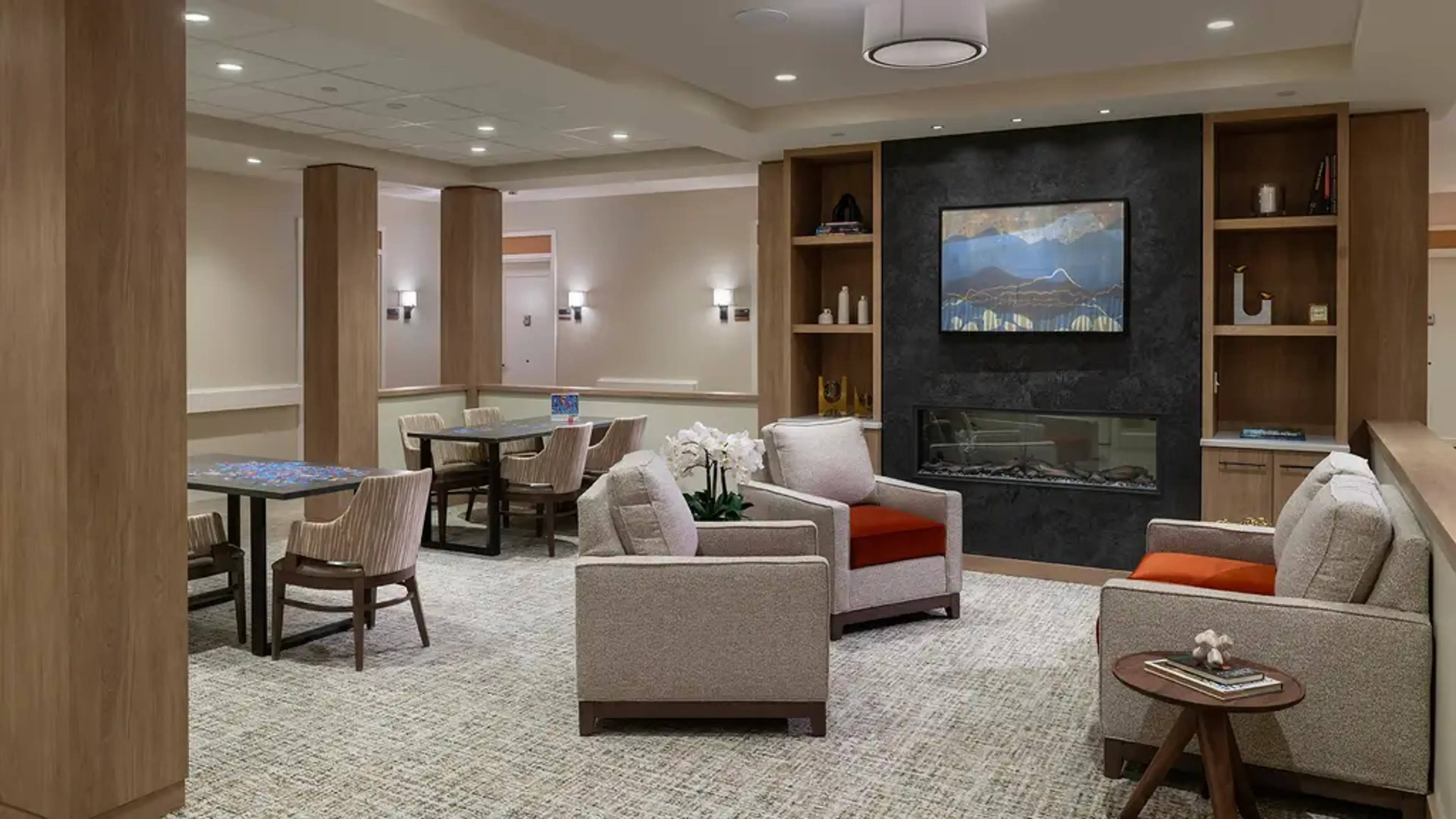 A common room with chairs and a tv