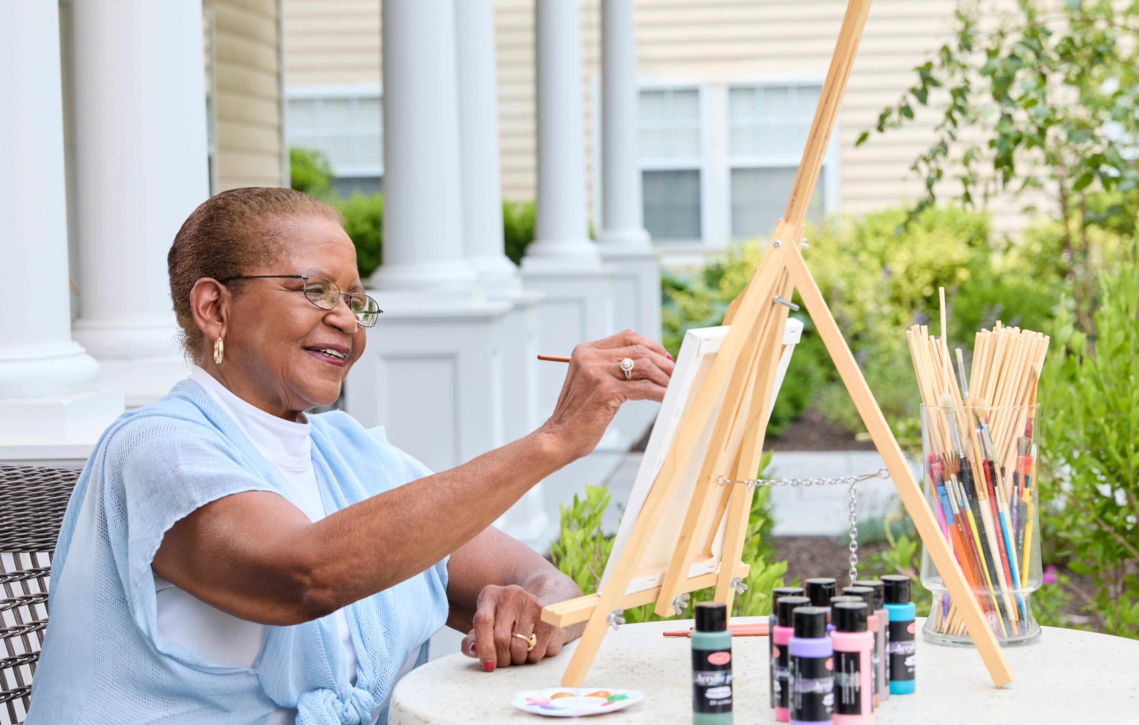 A senior woman painting