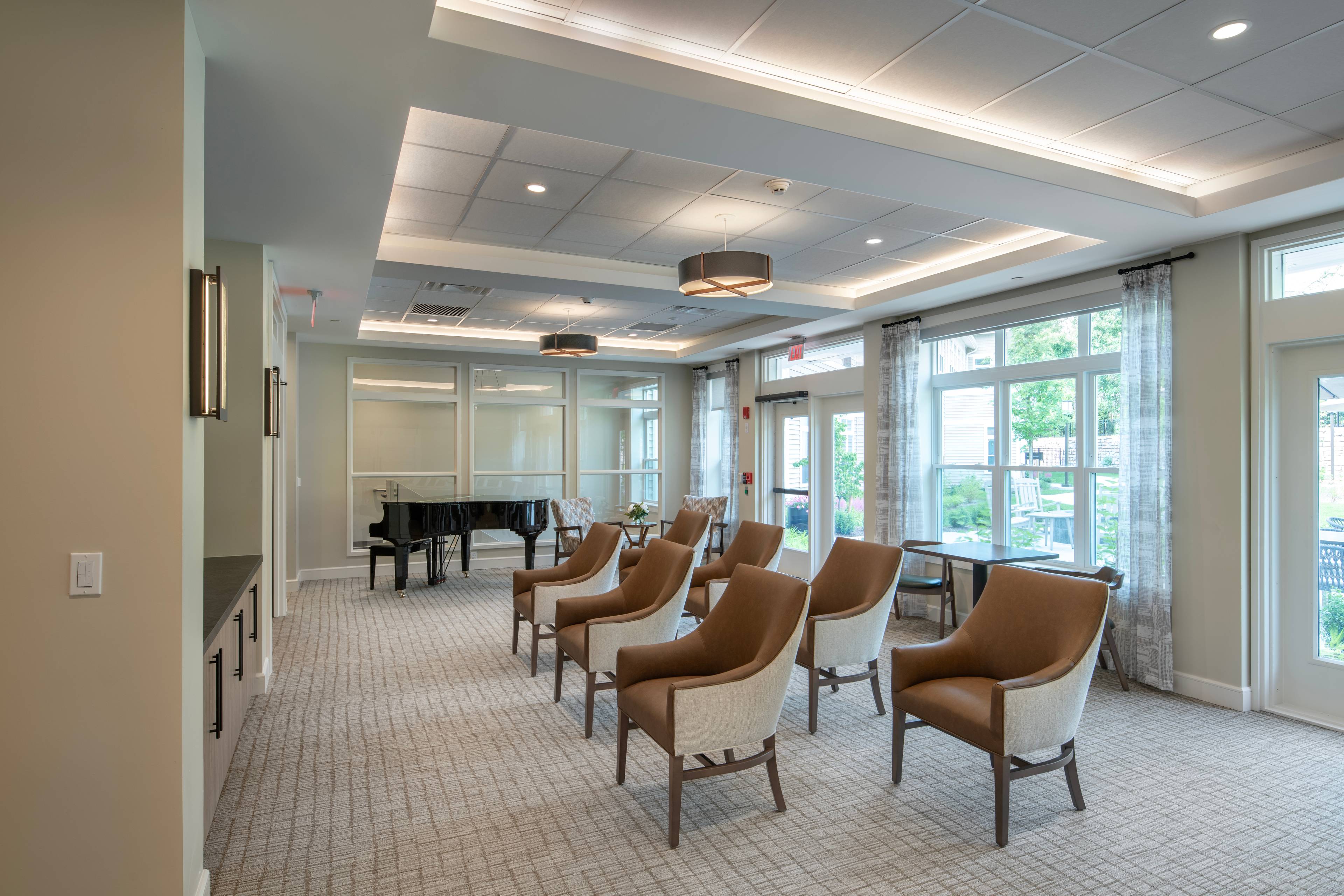 assorted rows of modern seating and a piano in the back