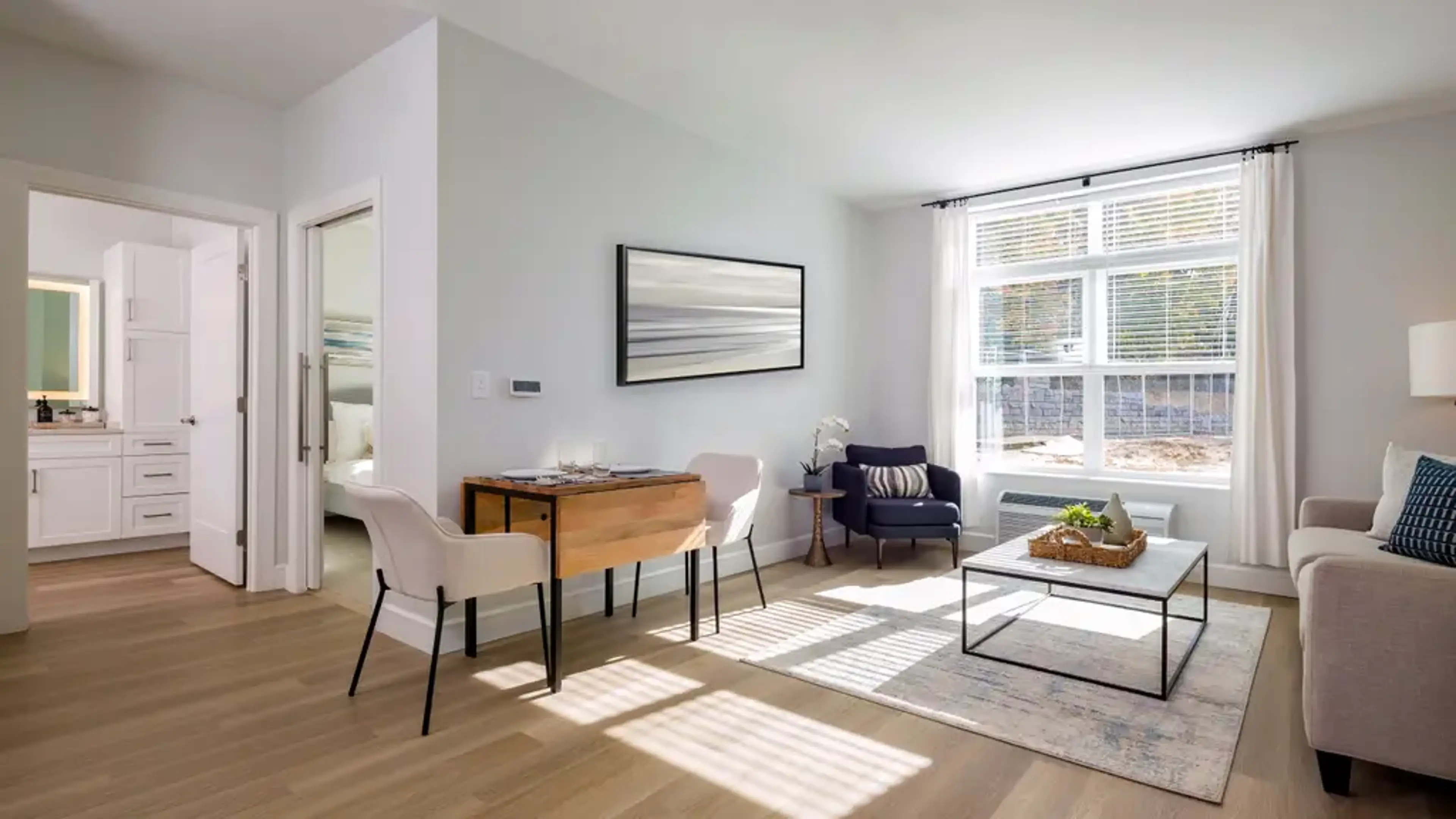A living room with a sable and painting