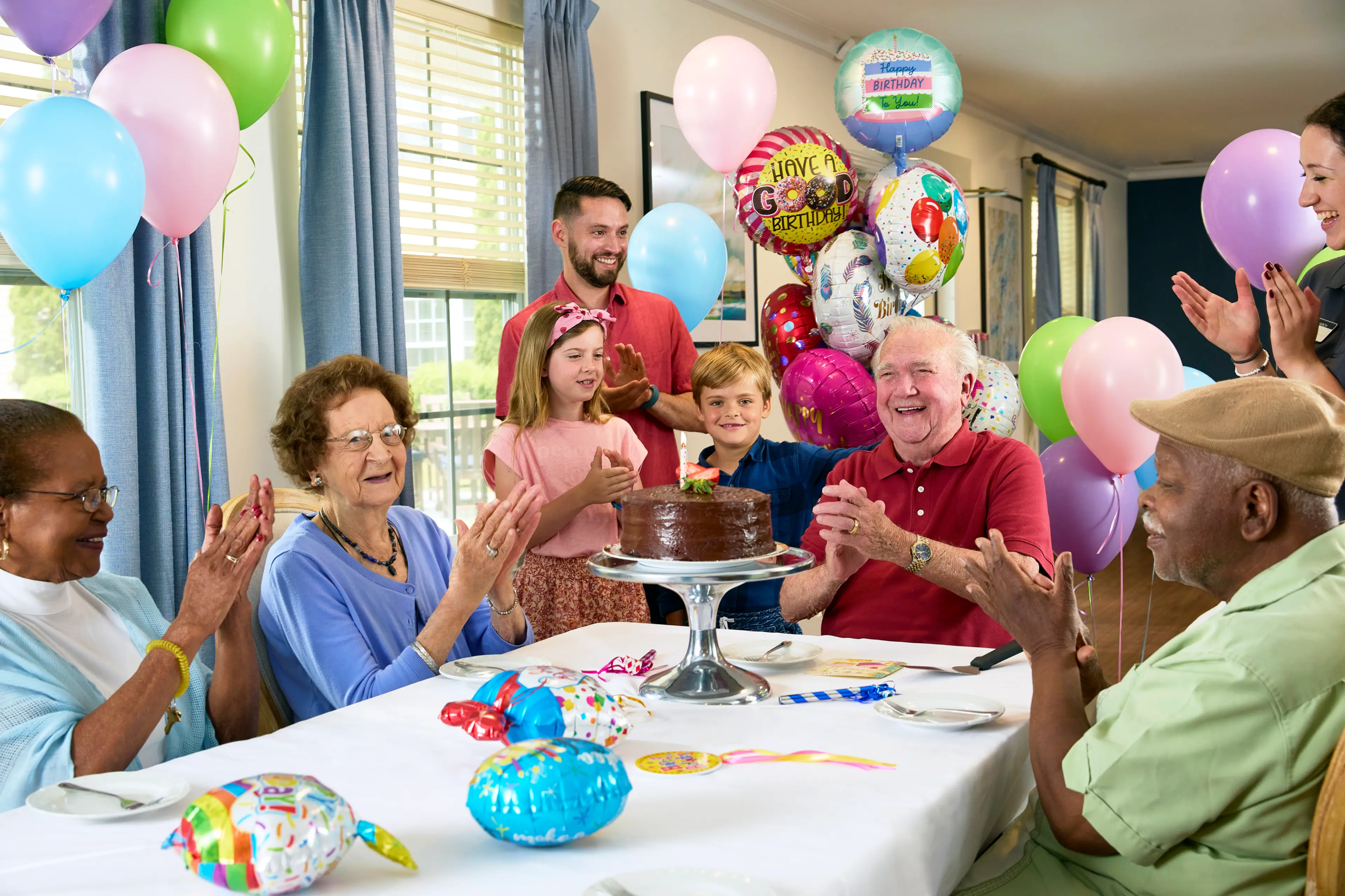 A senior celebrating a birthday with family.