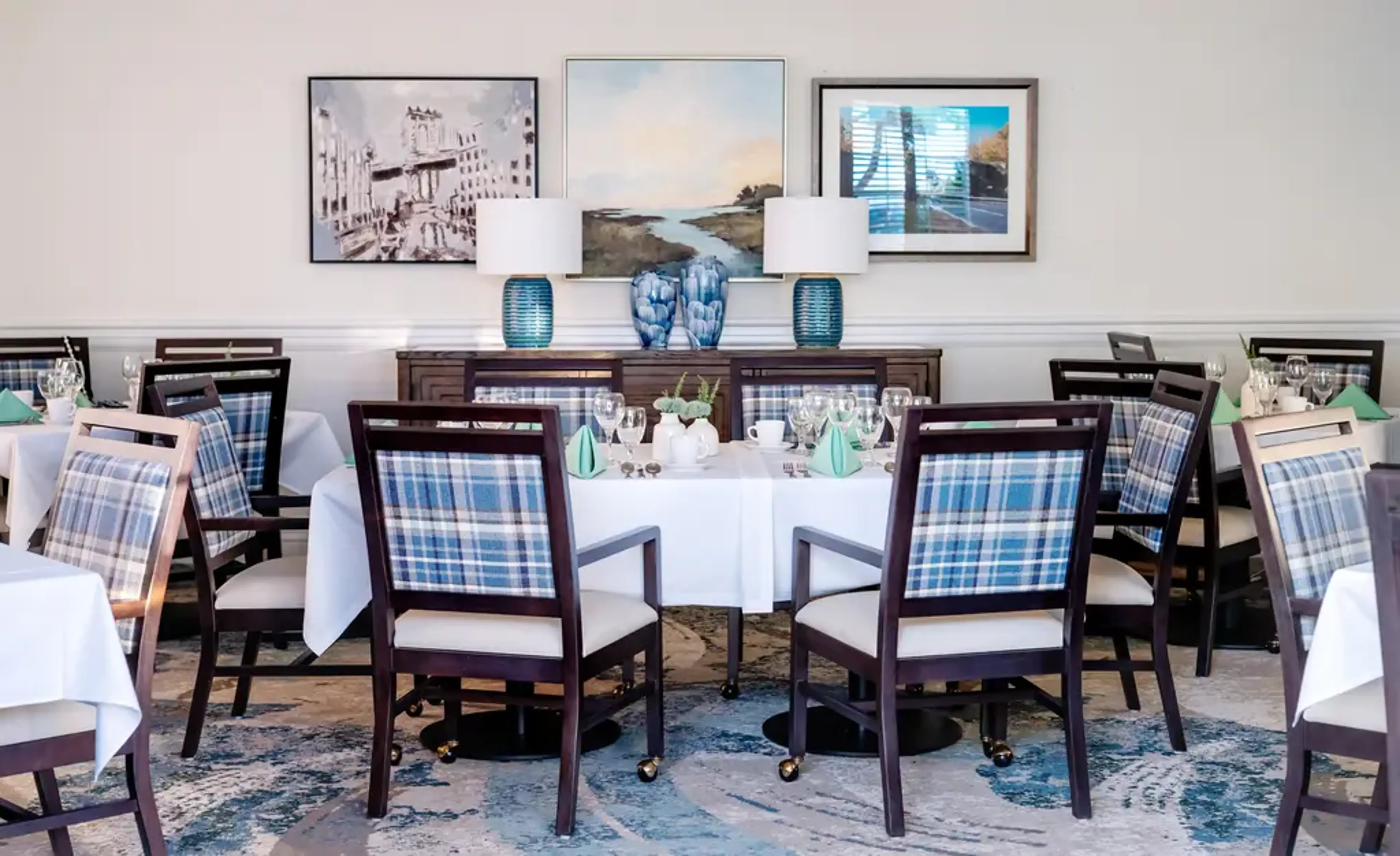 Dining room with a table, chairs, and lamps