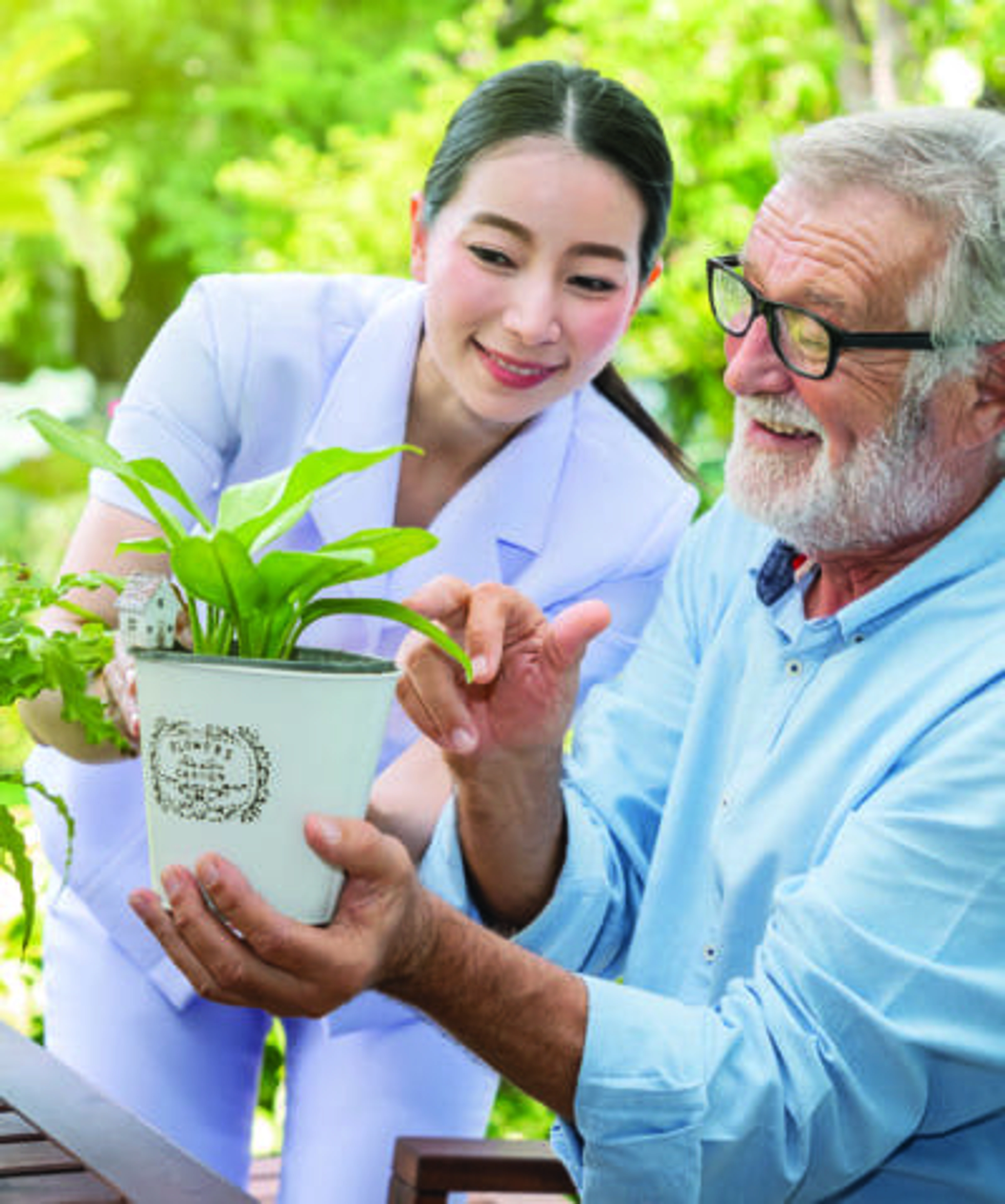 Man with caregiver and potted plant