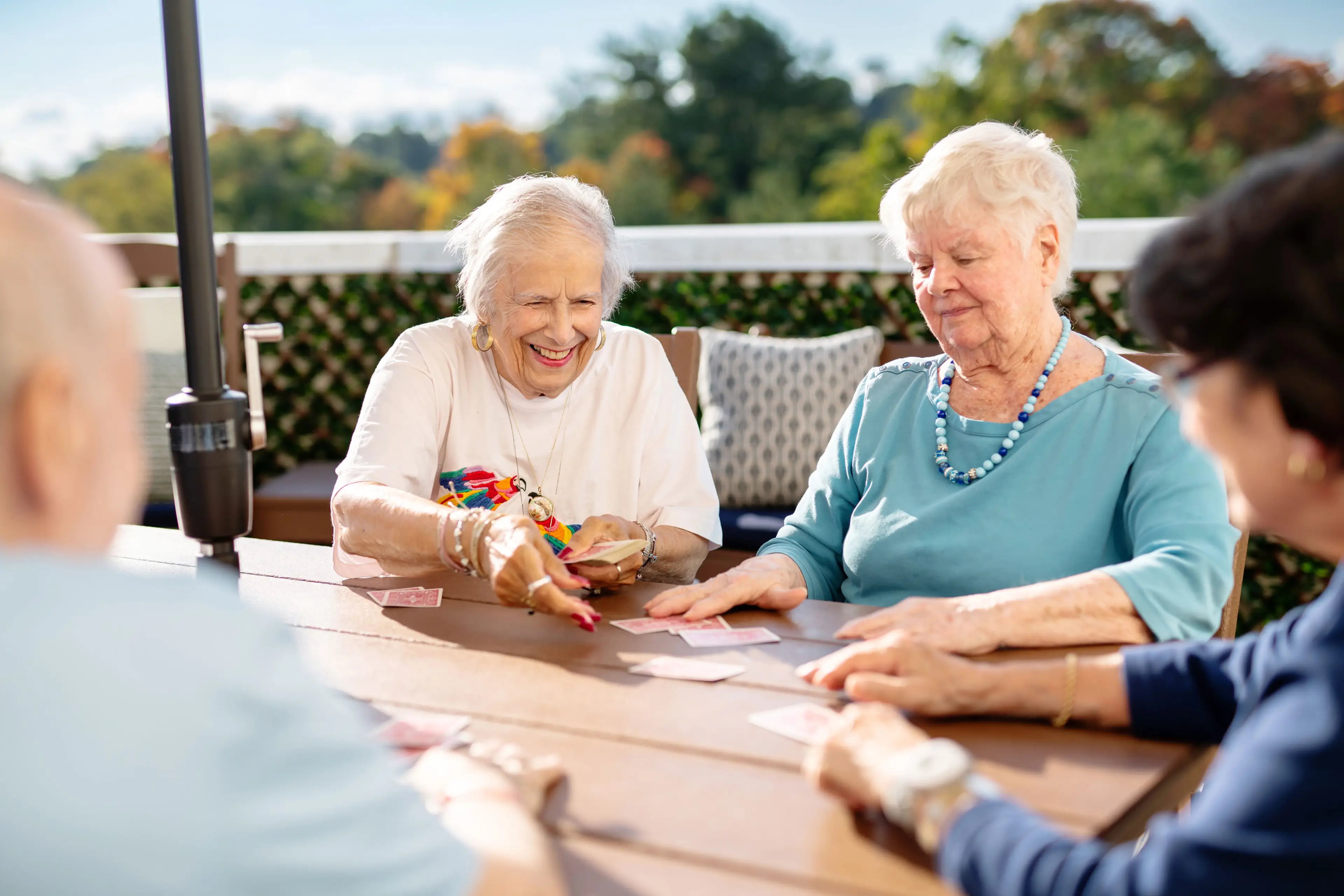 Residents playing cards on the patio