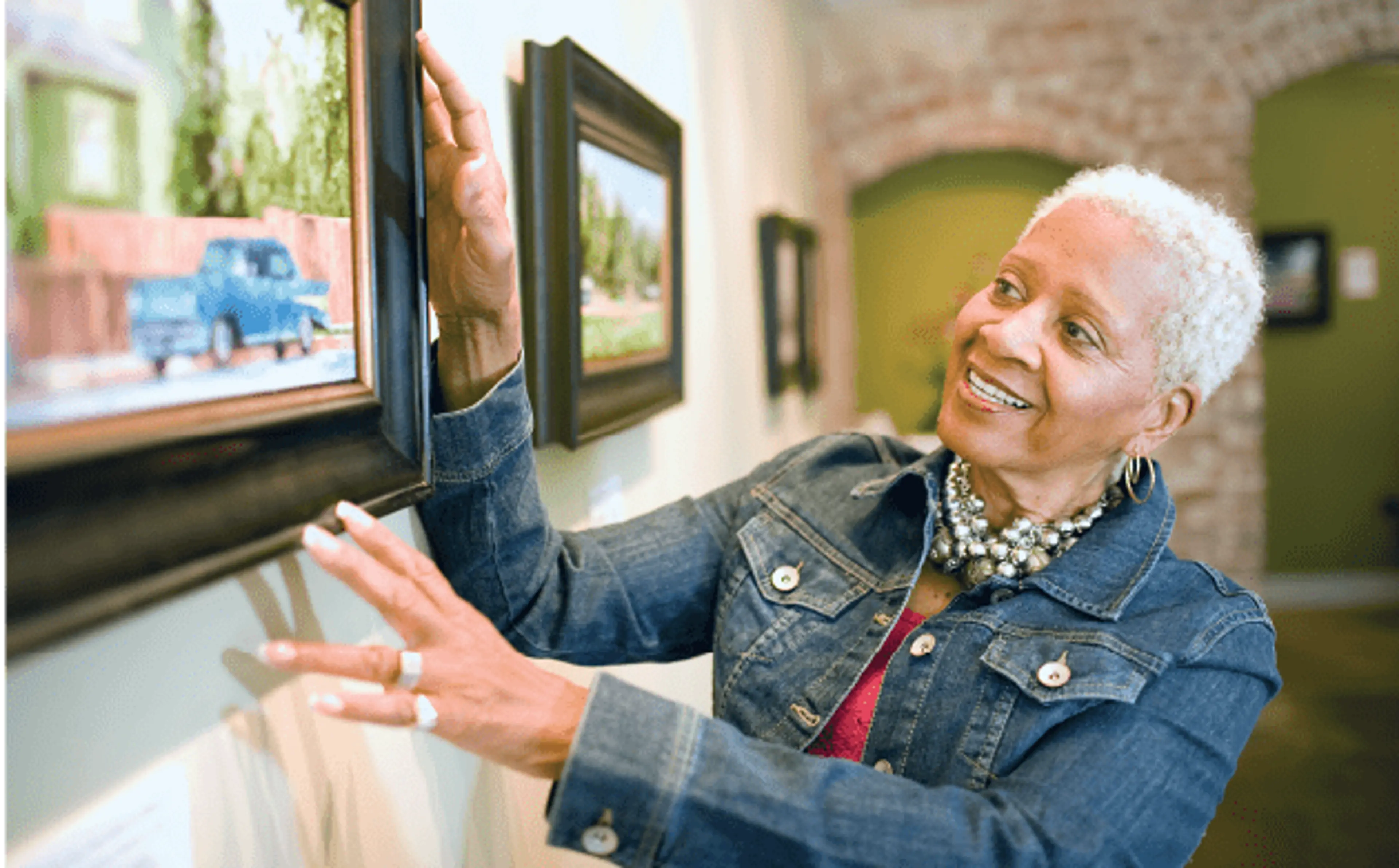Elderly Woman hanging artwork