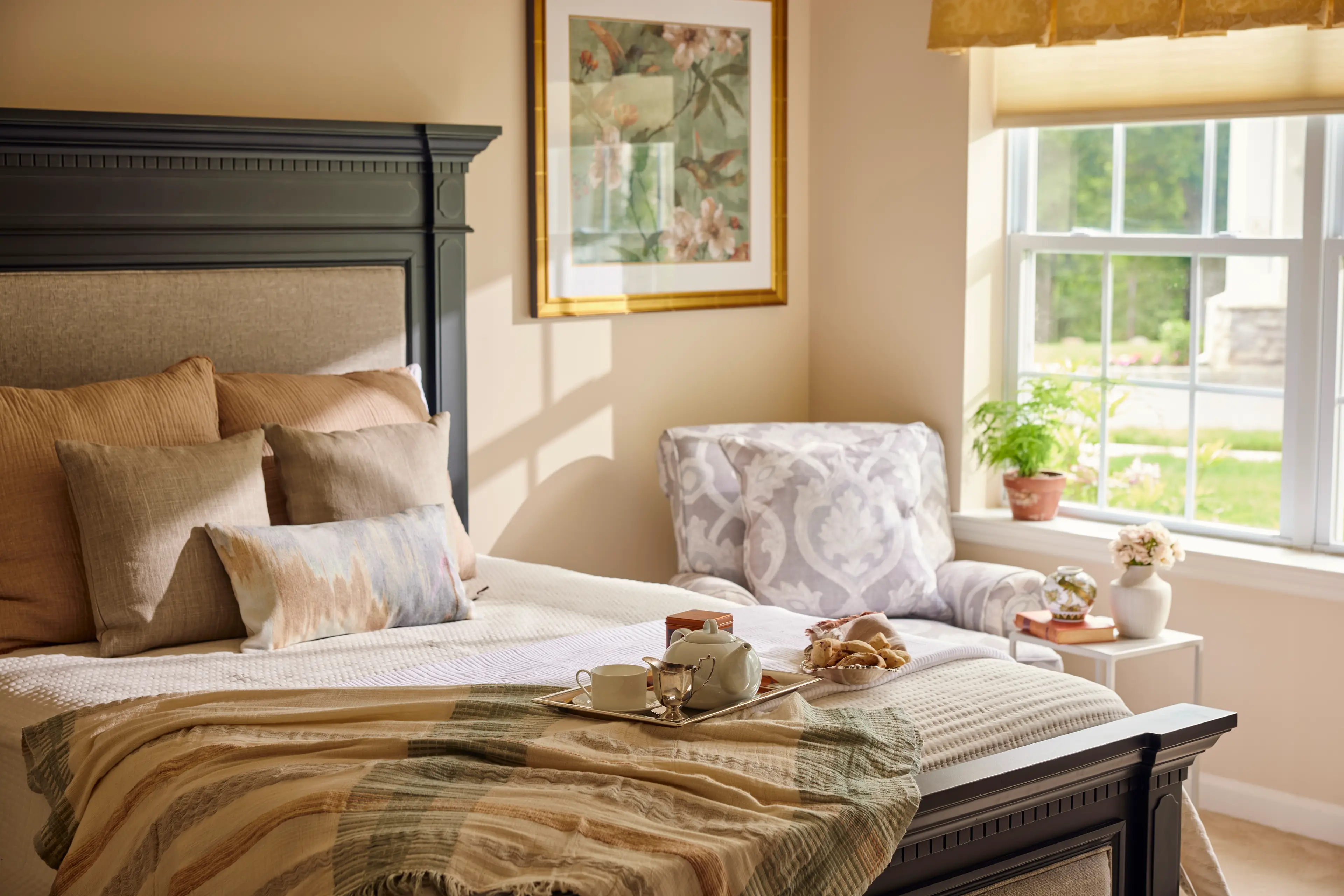 A bedroom with a serving tray on the bed