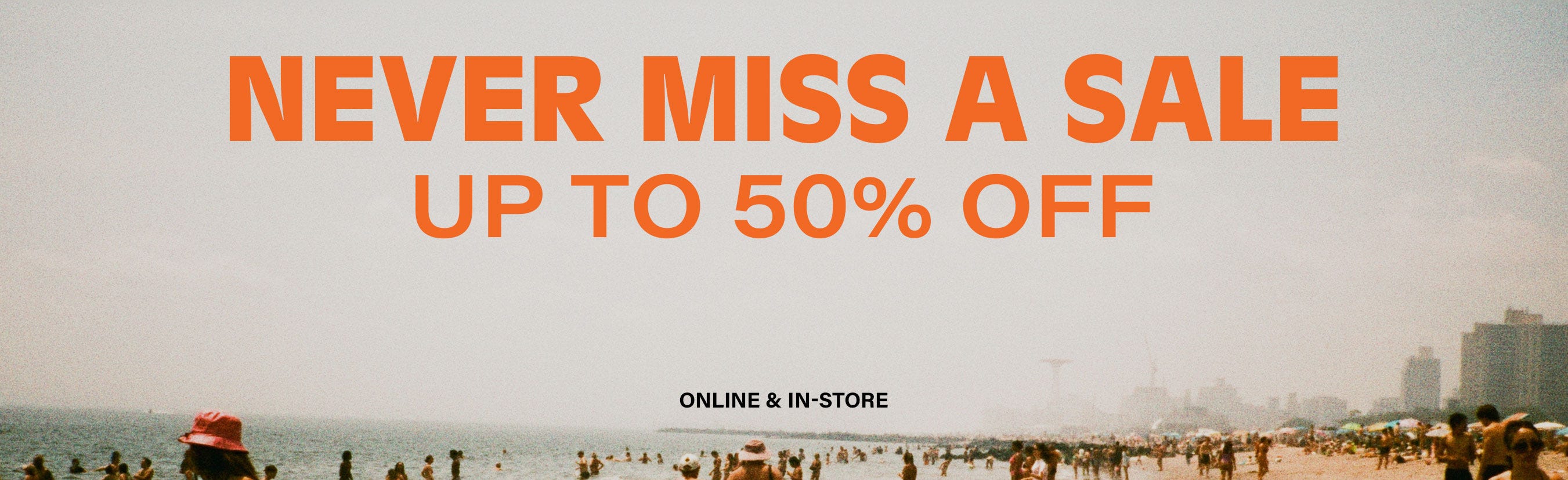A grainy image of a beach with the text 'Never miss a sale' in orange block letters
