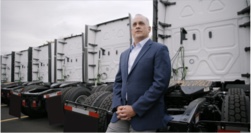 Man standing in front of trucks