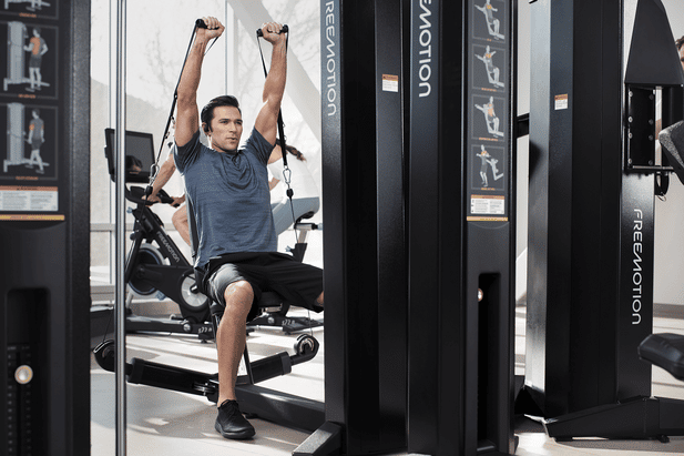 Smiling gym operator standing in a training facility