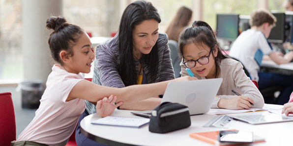 Tile | Two students learning with a teacher