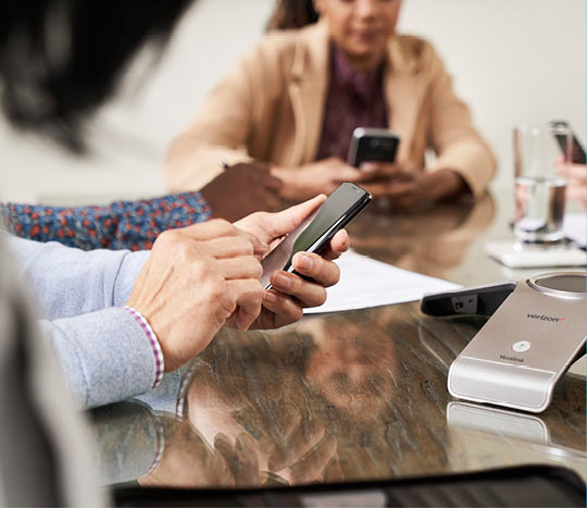 Sqre| Man using a mobile phone in a meeting