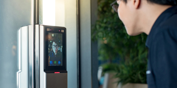 Person scanning face at a door scanner