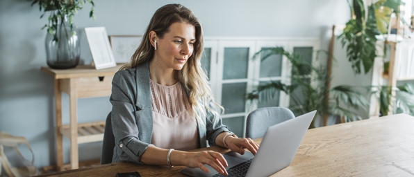 Full|woman typing on a laptop