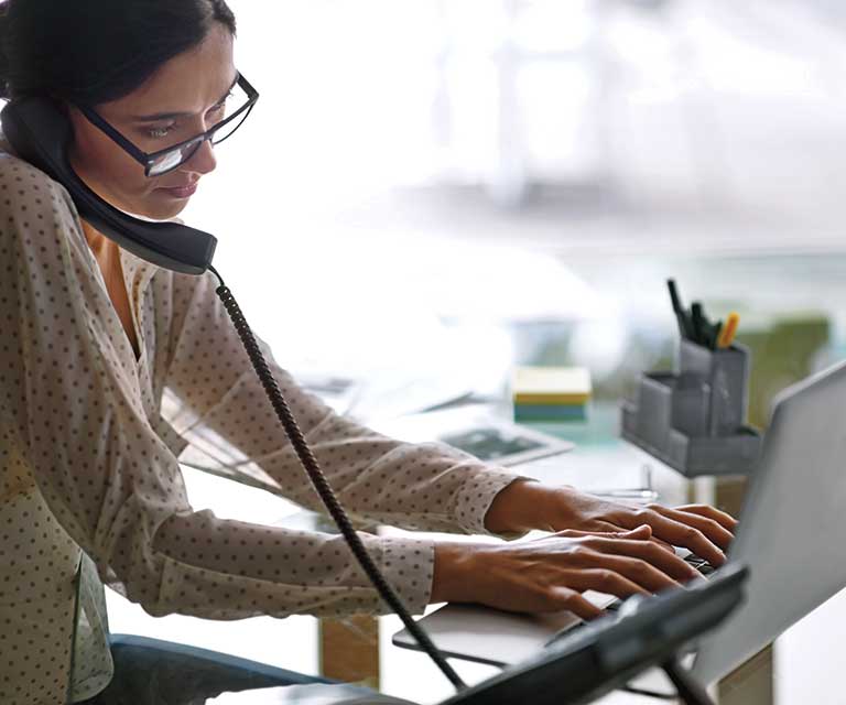 Tile|Woman on a phone using computer