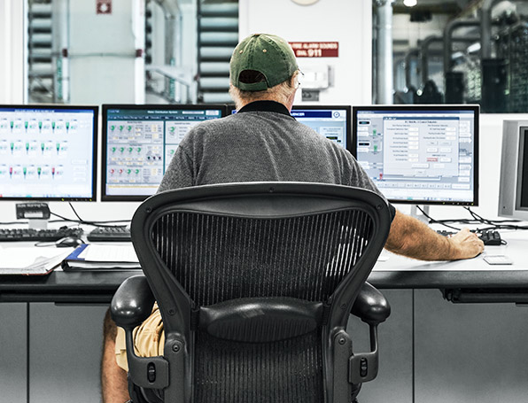 Sqre|Man at desk working on computer